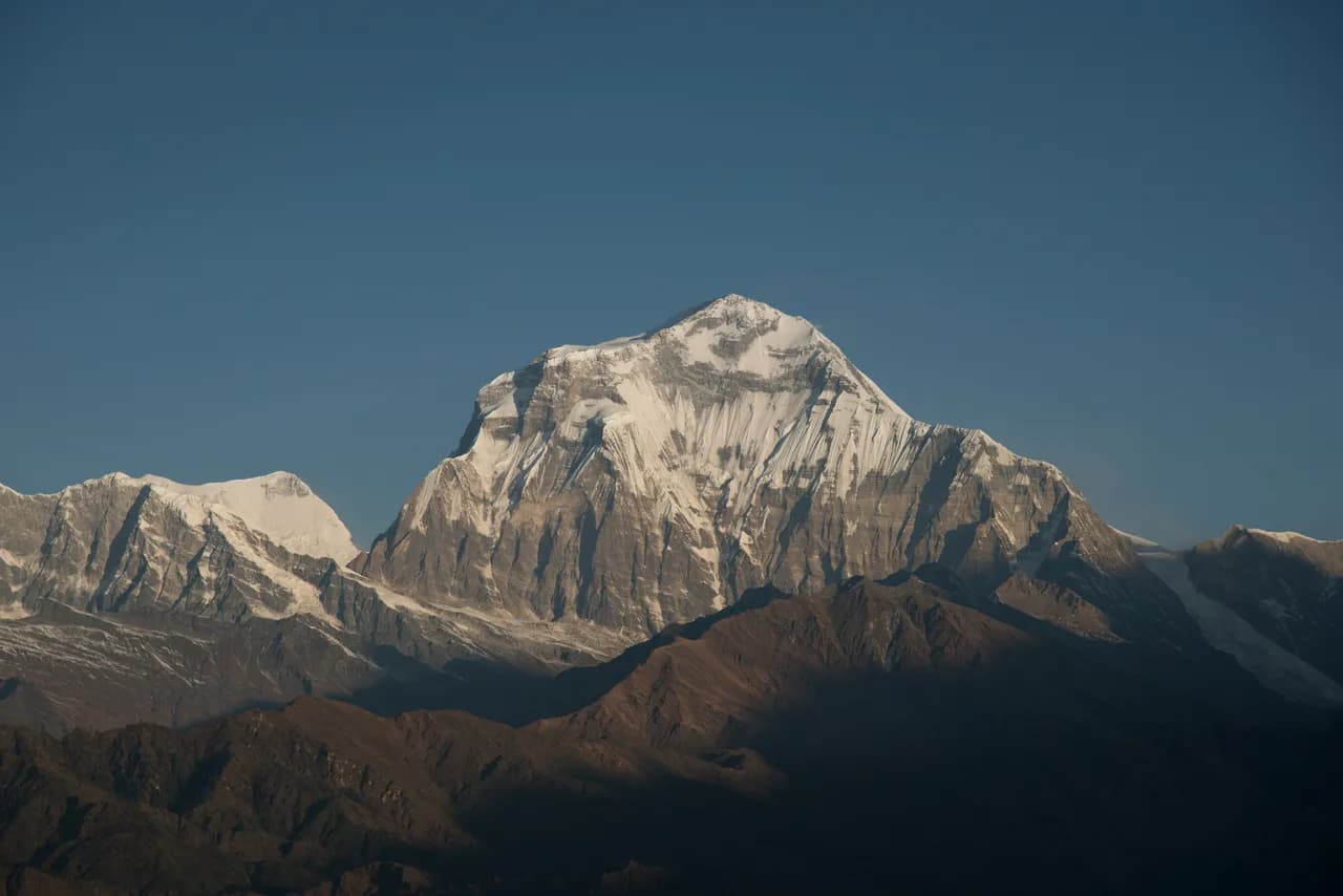 Snow-capped Dhaulagiri peak under clear blue sky viewed from Khopra Ridge trek, Annapurna region Nepal