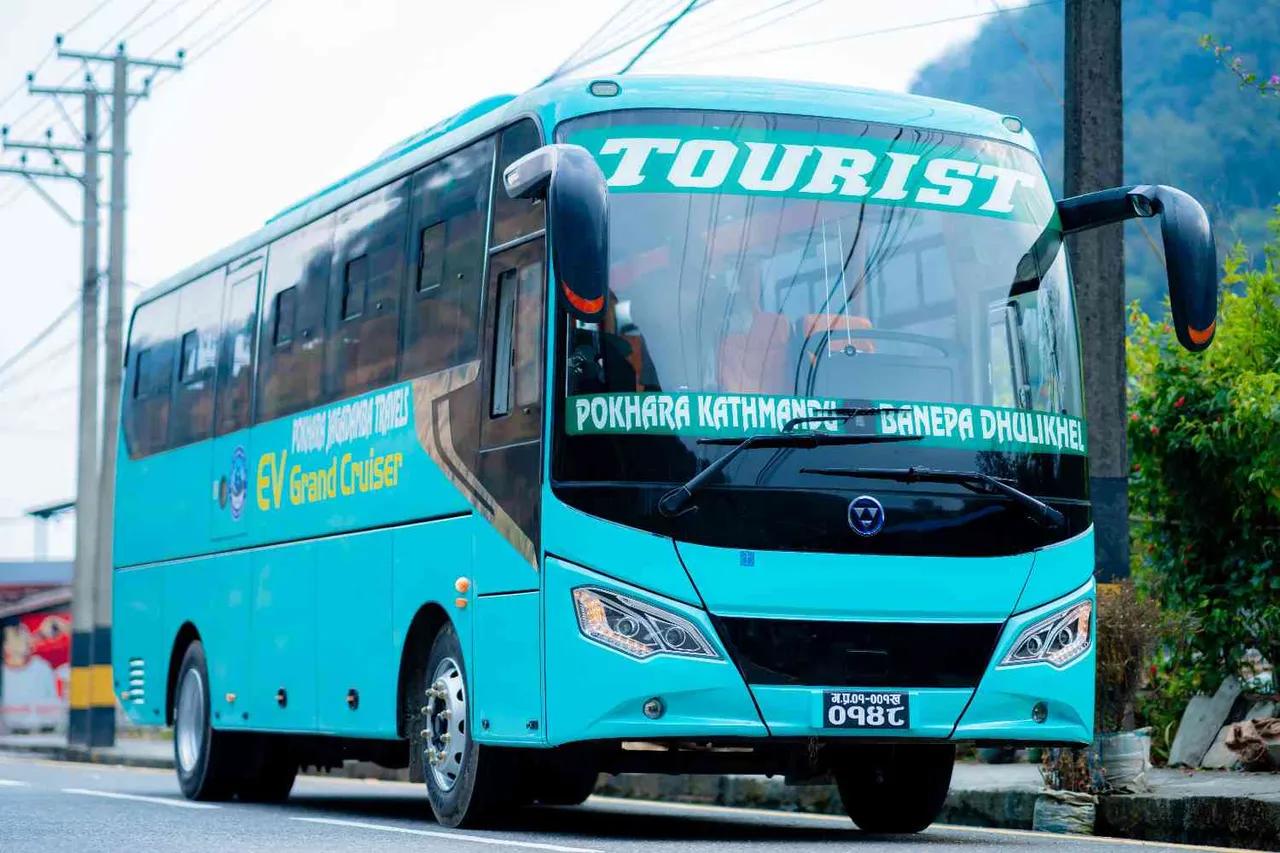 Light blue EV Grand Cruiser tourist bus on the Kathmandu to Pokhara route, Nepal