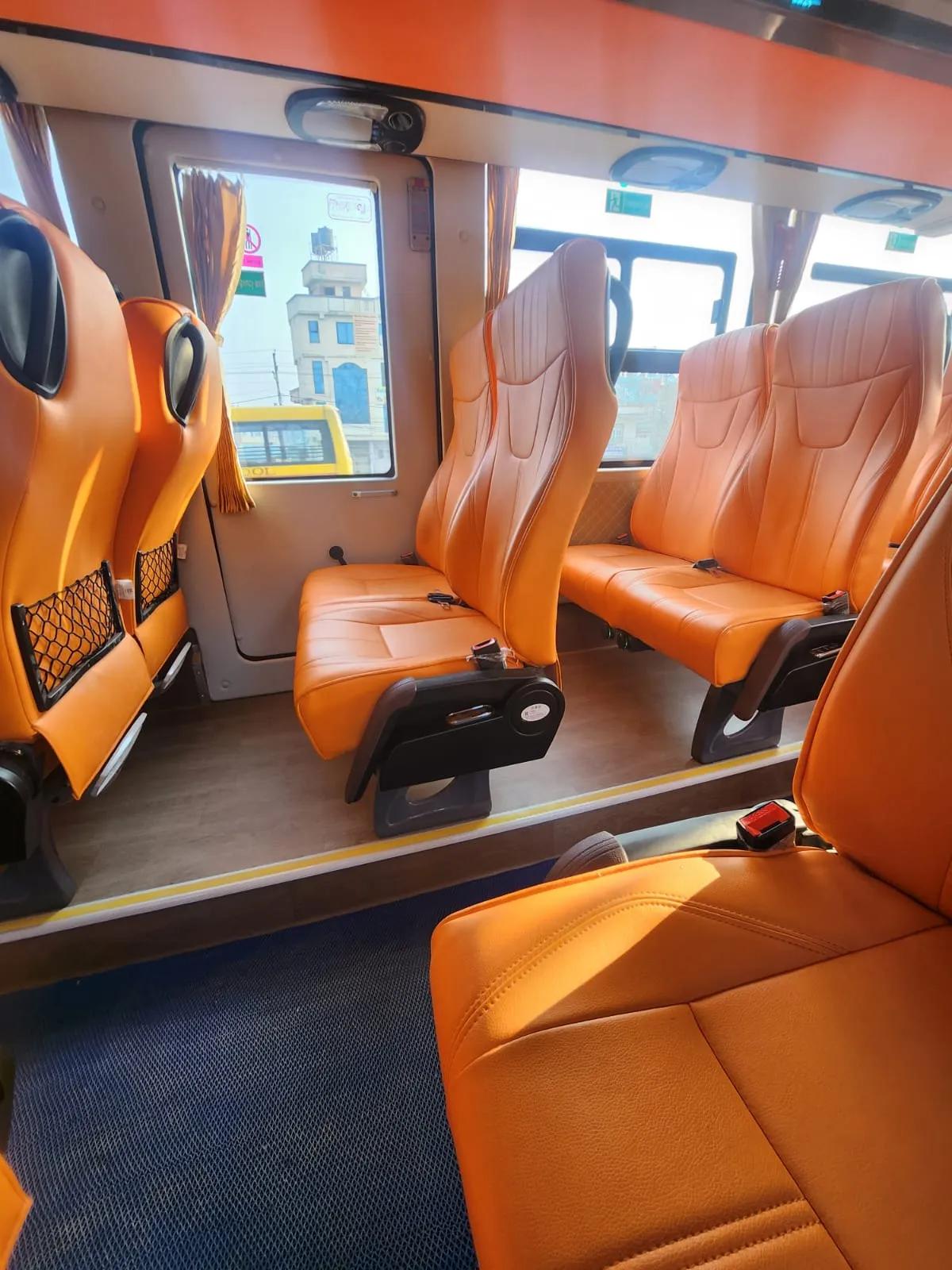 Inside the EV Grand Cruiser — the orange seats, wide windows, and clean cabin were not what a Rs. 874 ticket prepared me for.