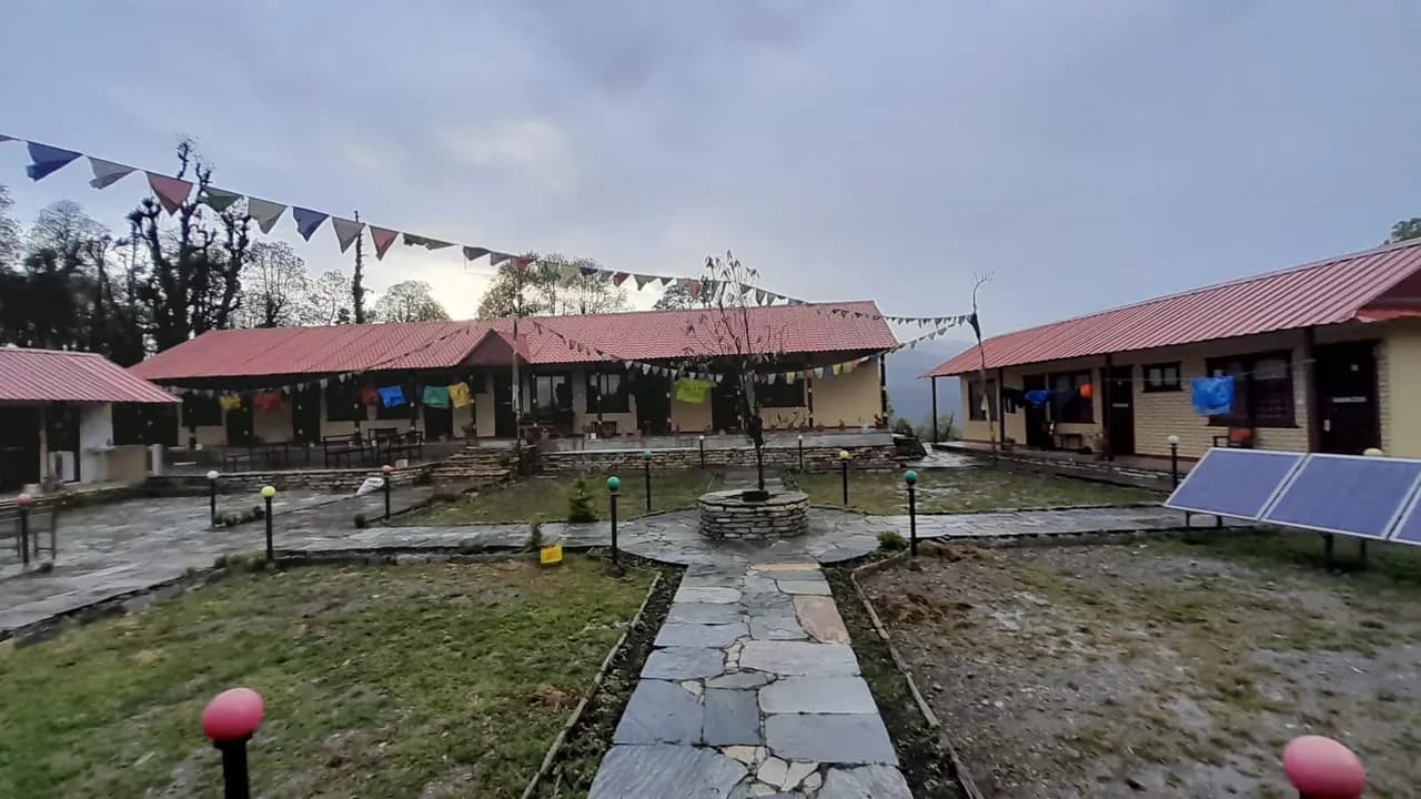 The lodge at Ghorepani — quiet, damp, and still. The prayer flags the only colour in an otherwise grey afternoon.